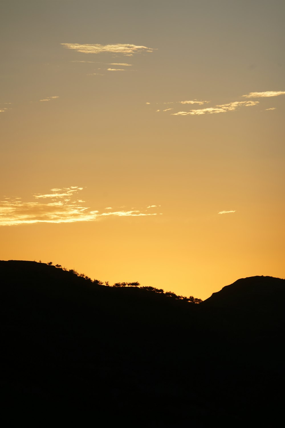 a landscape with hills and a blue sky