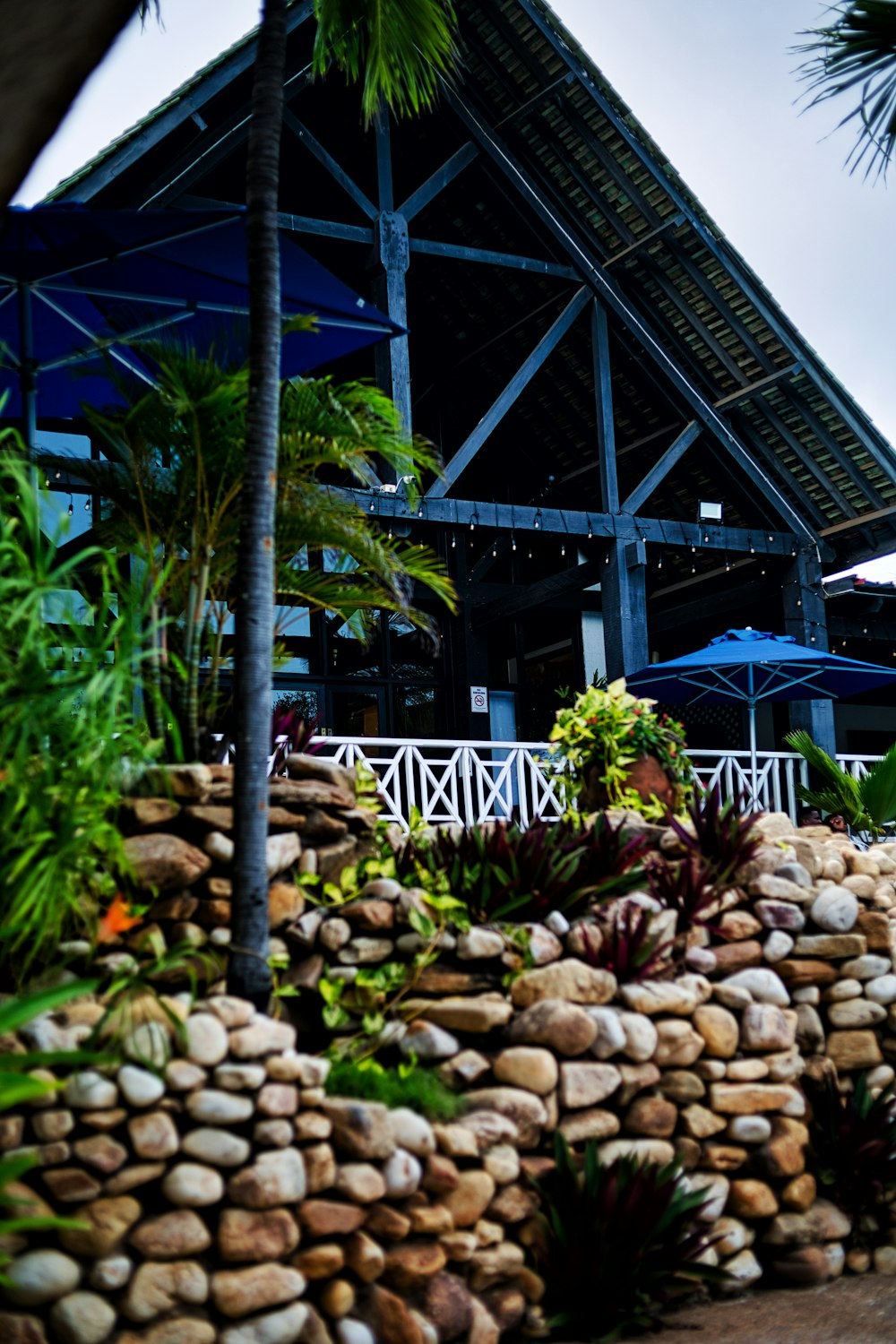 a large metal structure with a walkway and plants around it