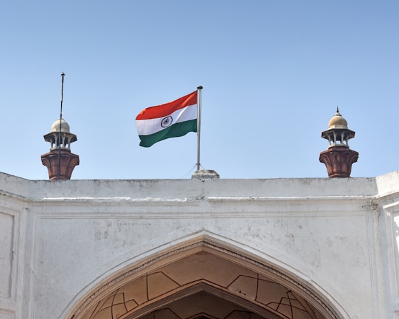 A dignified Indian institutional building with traditional architectural elements under a clear sky.