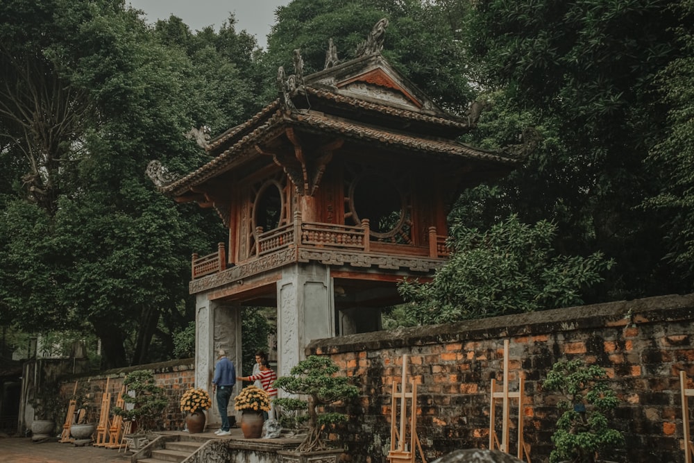a pagoda with a couple people standing in front of it