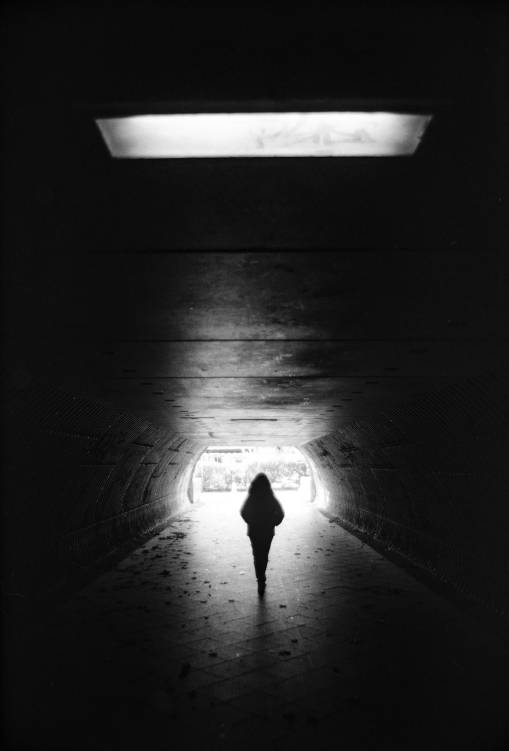 a person walking in a dark room