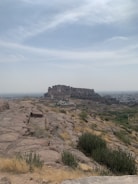 A detailed view of a fortified base with barricades and watchtowers under a stormy sky.