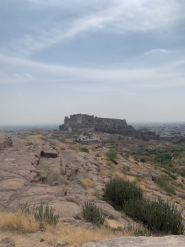 A detailed view of a fortified base with barricades and watchtowers under a stormy sky.