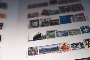 A collection of colorful historic stamps arranged neatly on a wooden table