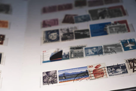 A close-up of vintage postage stamps arranged neatly on an album page.
