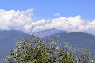a view of a mountain range with clouds in the sky