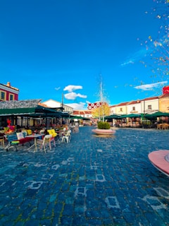 A cozy café terrace in Buenos Aires with soft white and light blue decor under a clear sky.