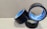 Three rolls of black adhesive tape with blue inner linings are placed on a textured cardboard surface. The rolls are partially unwound, and each displays the brand name 'Stefil' on the inside.