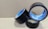 Three rolls of black adhesive tape with blue inner linings are placed on a textured cardboard surface. The rolls are partially unwound, and each displays the brand name 'Stefil' on the inside.