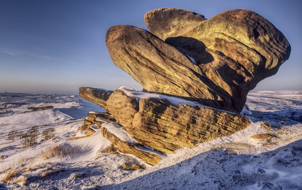 a large rock formation in the snow