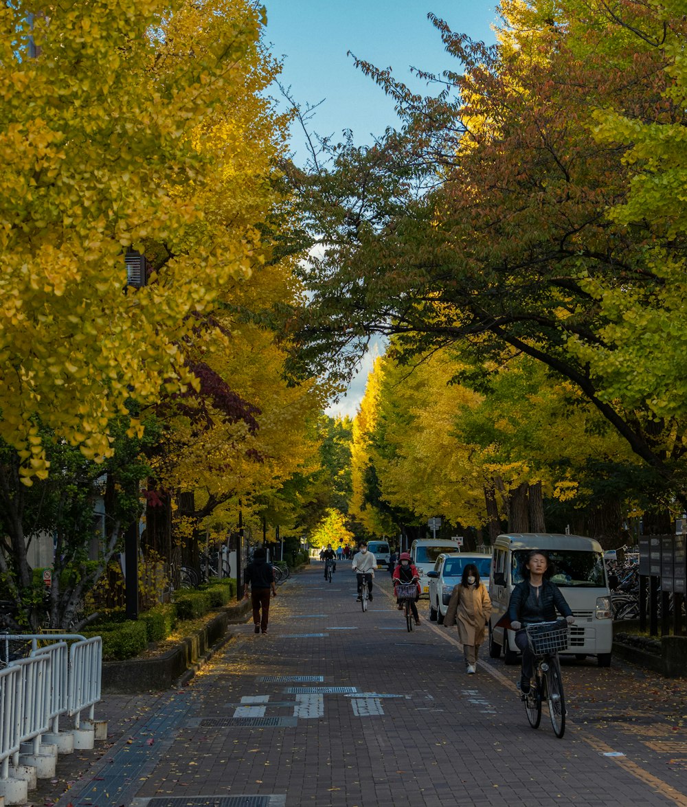 people riding bikes on a sidewalk