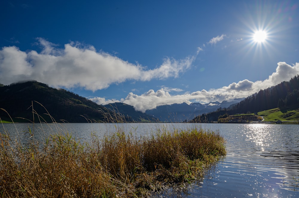 a body of water with mountains in the background