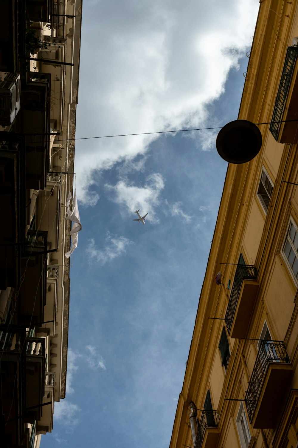 a plane flying over buildings