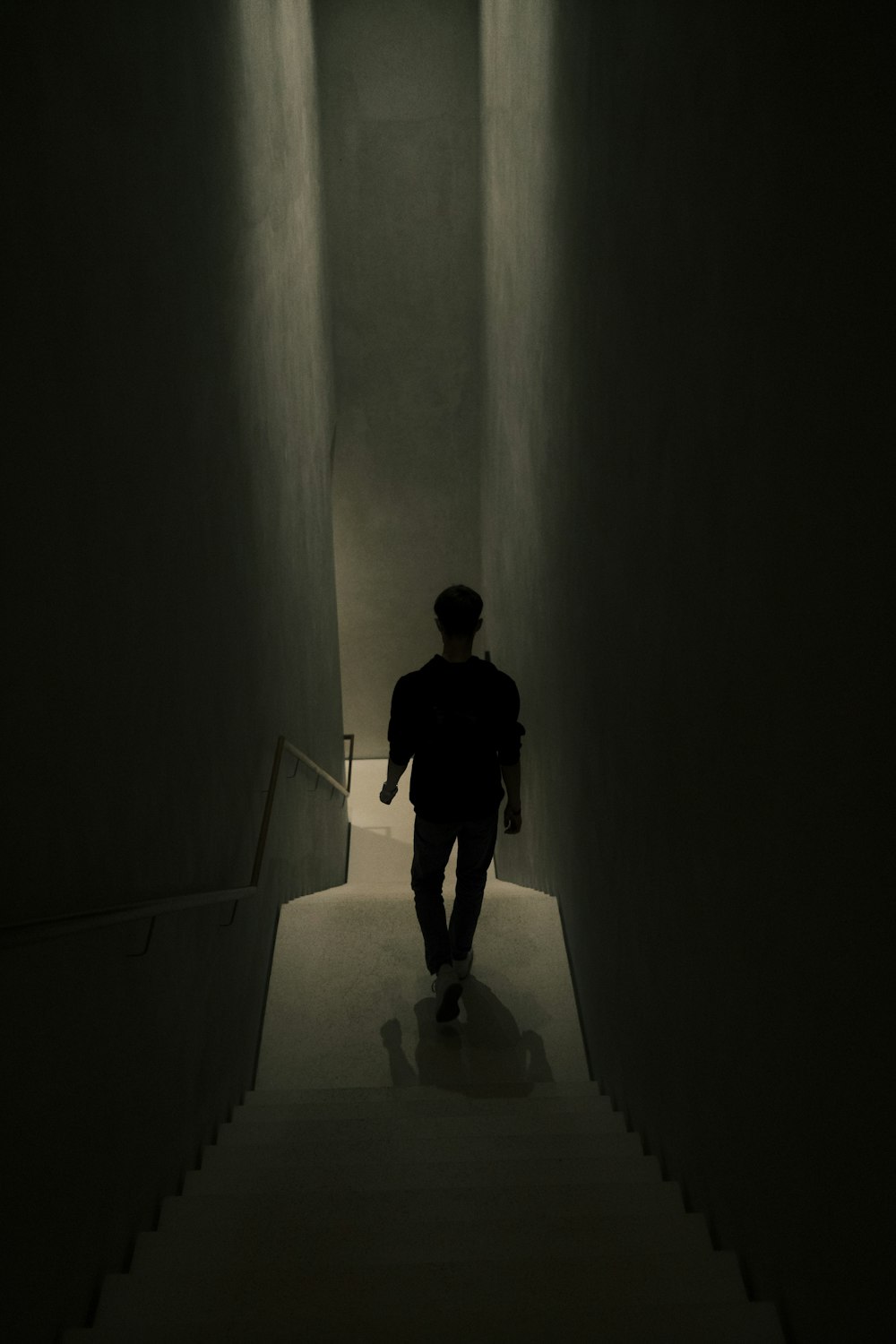 a man walking down a dark hallway