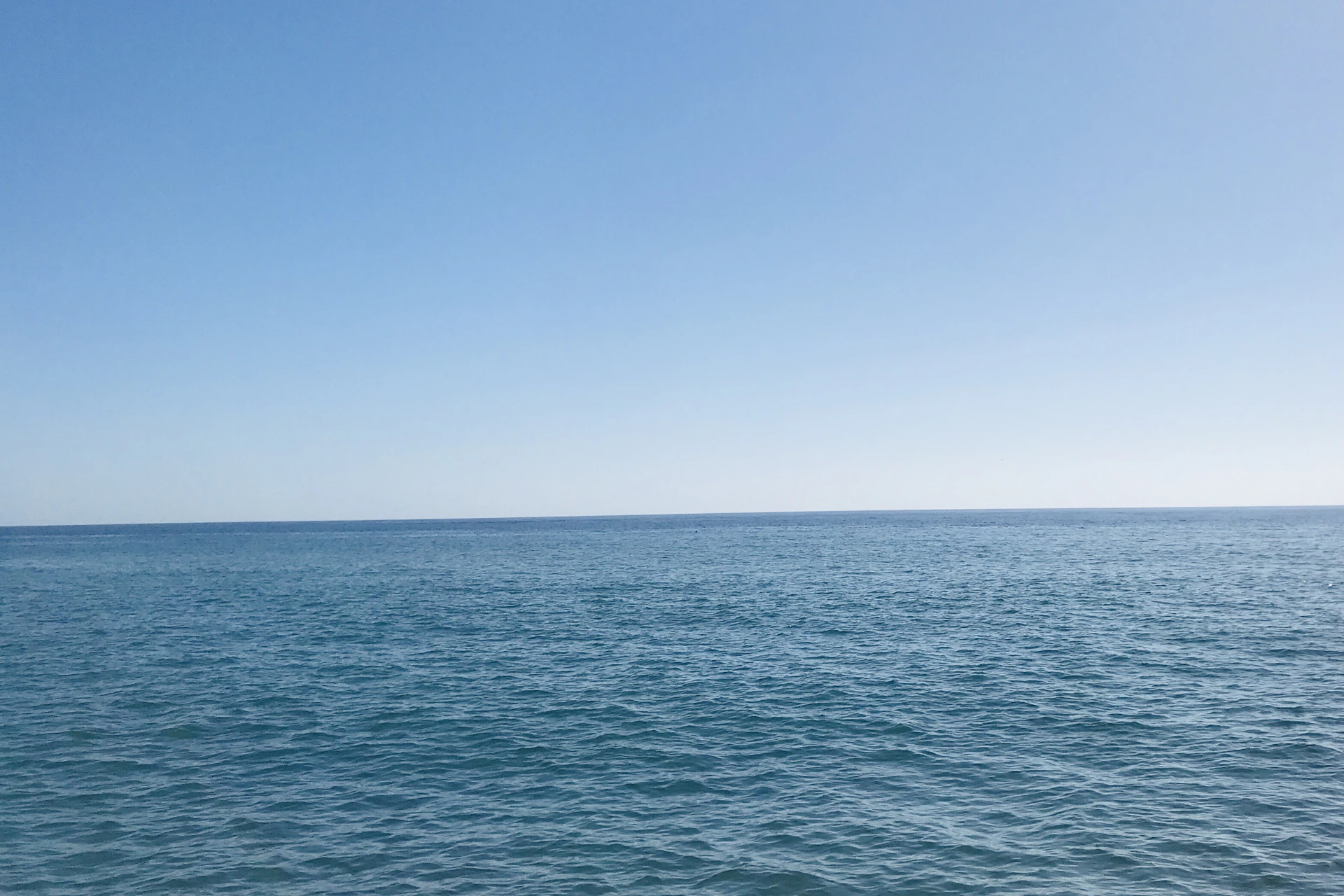 a body of water with blue sky