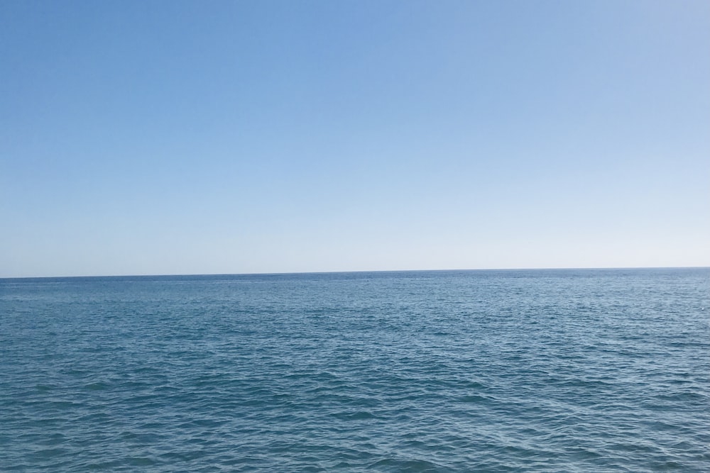 a body of water with blue sky