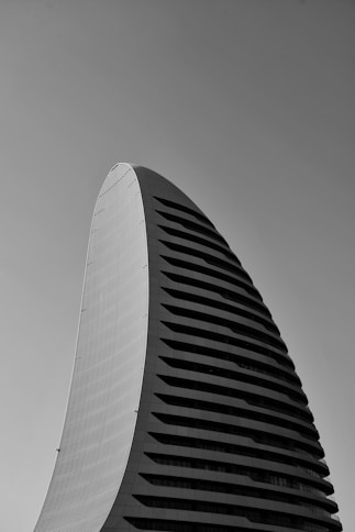 a tall building with a cloudy sky