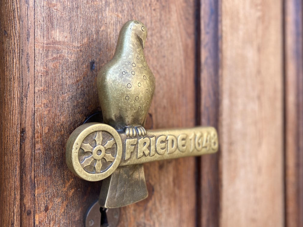 a metal door handle with a green handle and a green circle on it