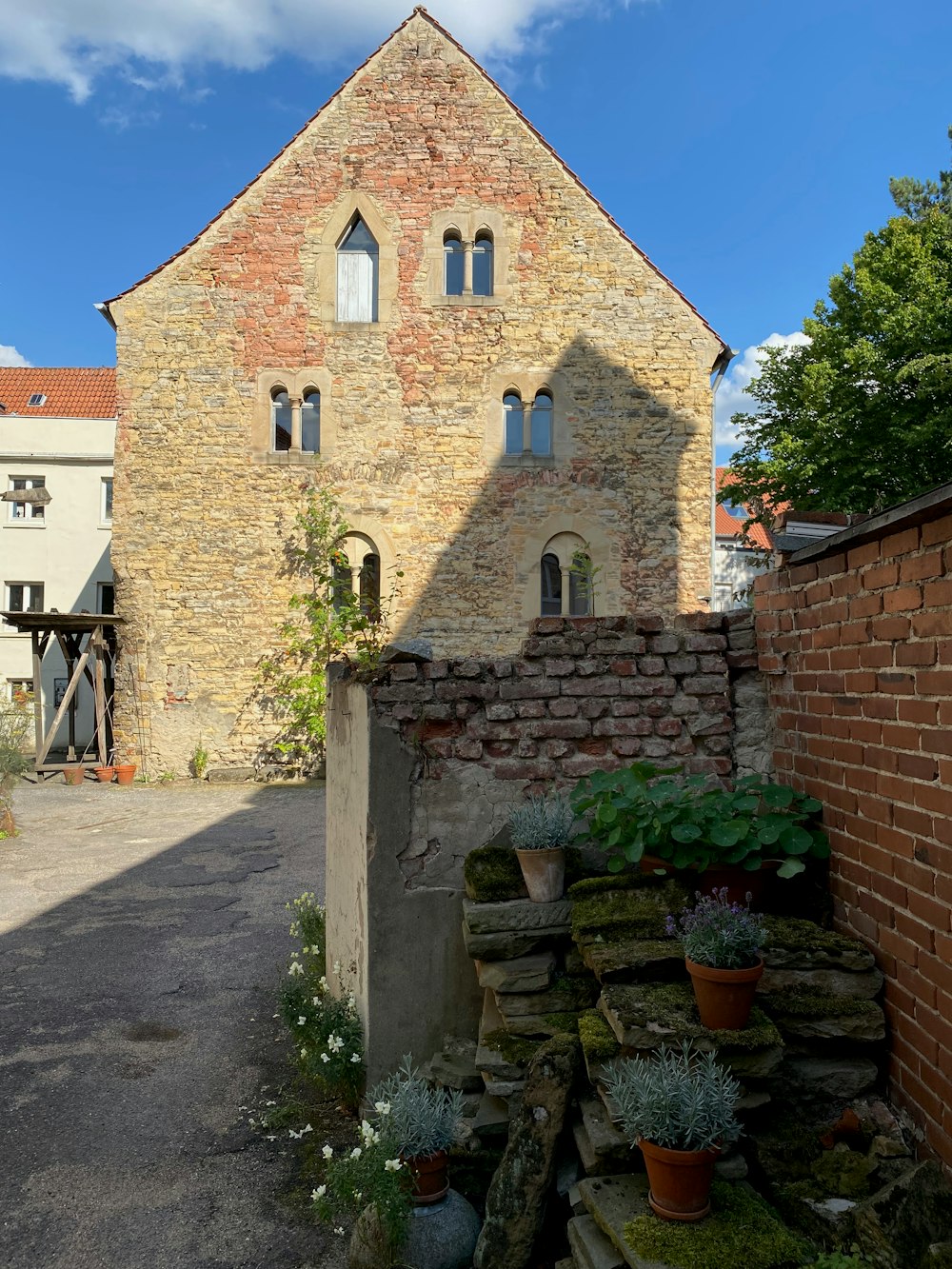 a brick building with a garden in front of it