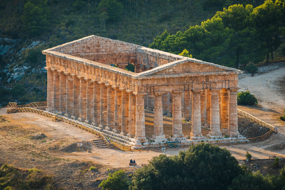 a building with columns and a road