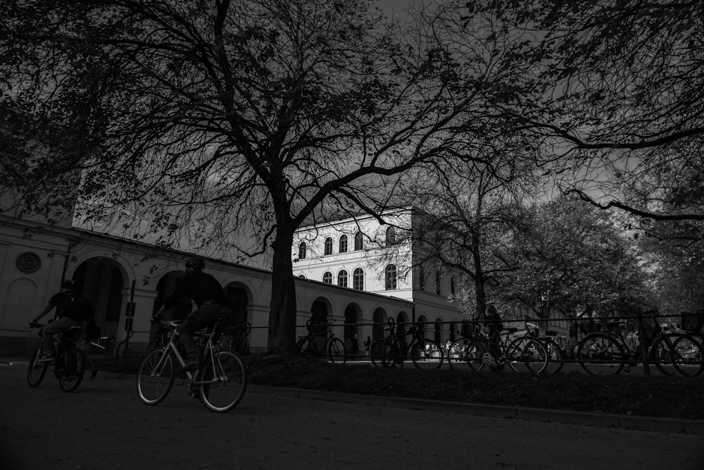 a group of people riding bikes on a street