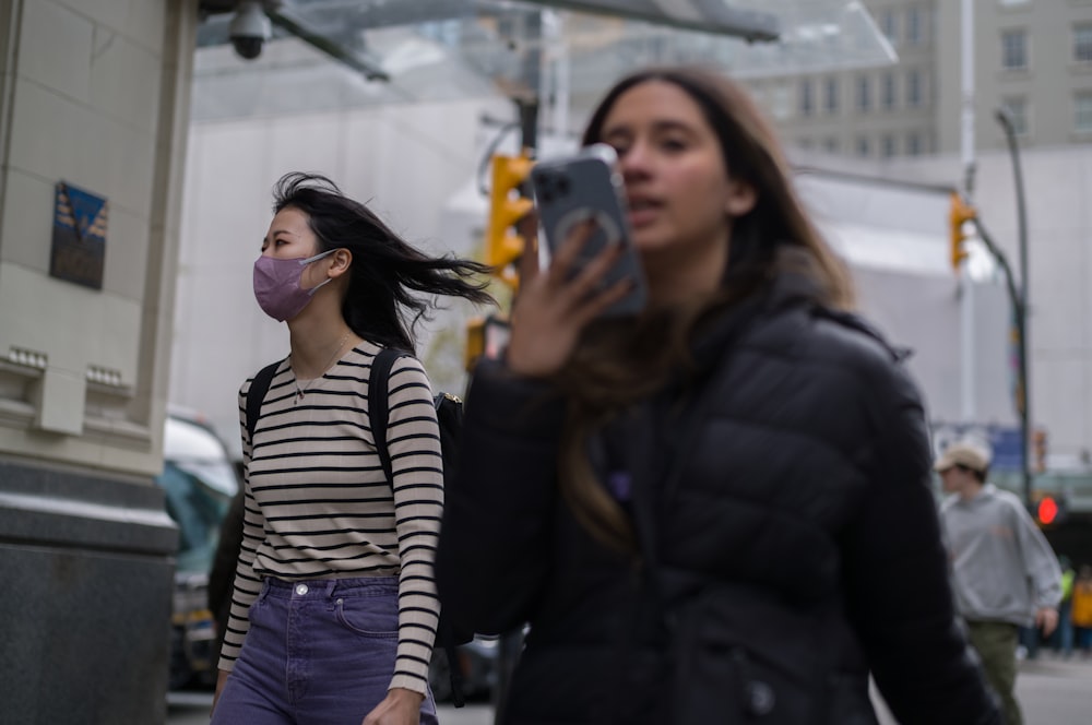 a woman taking a picture of another woman