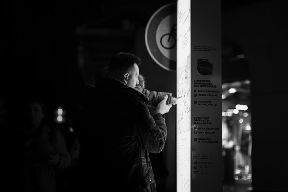 a person standing next to a sign