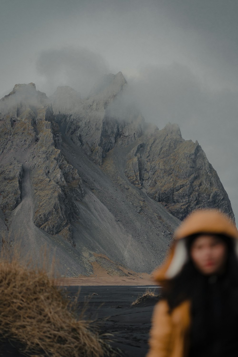 a person standing in front of a mountain