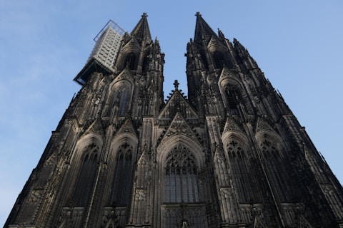 a large stone building with Cologne Cathedral in the background