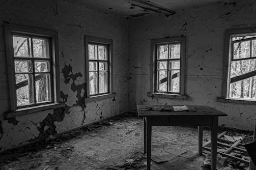 An abandoned room with dust-covered furniture.