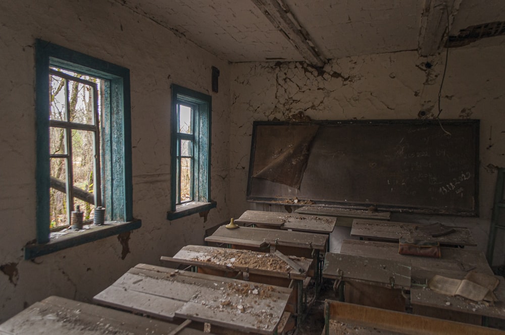 an abandoned room with broken windows