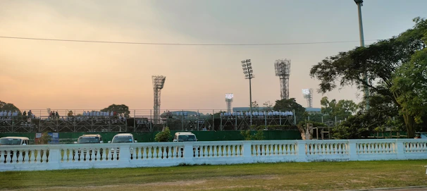 A dynamic scene of a corporate sports day with teams competing under stadium lights.