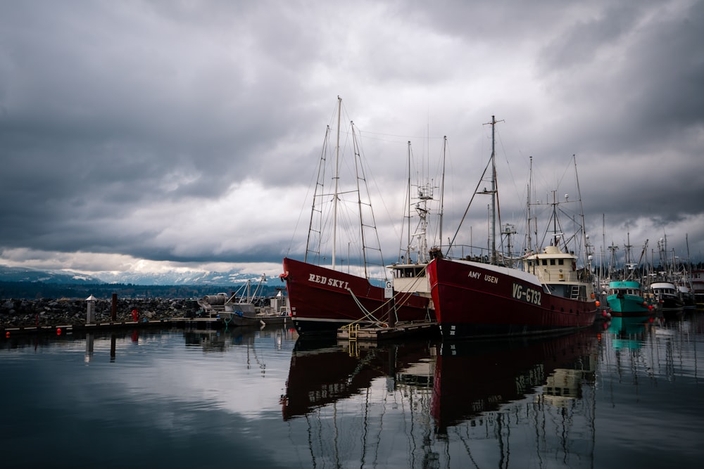 a group of boats sit in a harbor