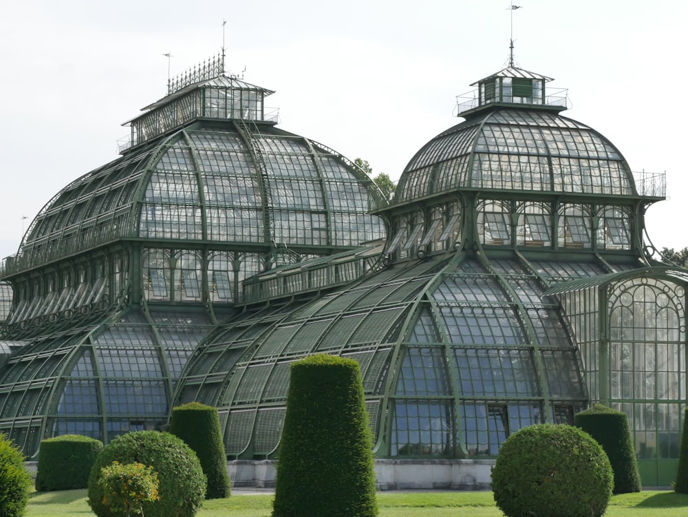 a large glass building with a dome roof