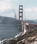 a large bridge over water with Golden Gate Bridge in the background