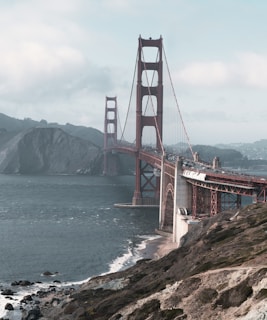 a large bridge over water with Golden Gate Bridge in the background