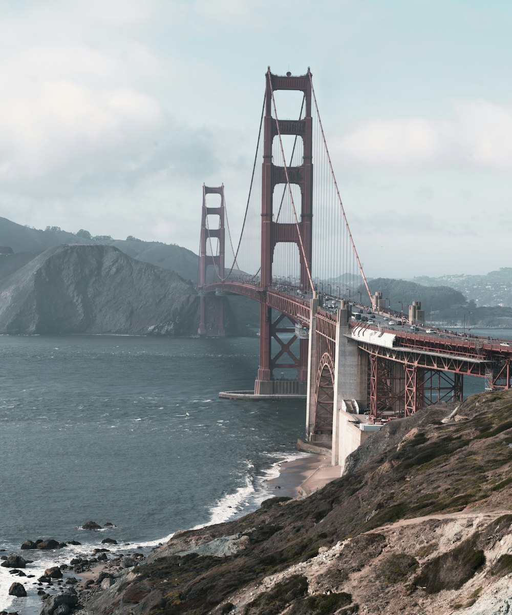 a large bridge over water with Golden Gate Bridge in the background