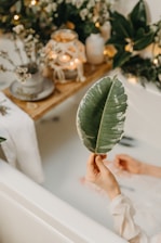 a person's feet on a table with a plant and a tree