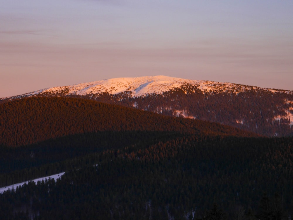 a mountain with a snow covered peak