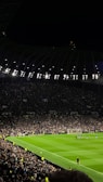 A panoramic view of a packed football stadium during a night match