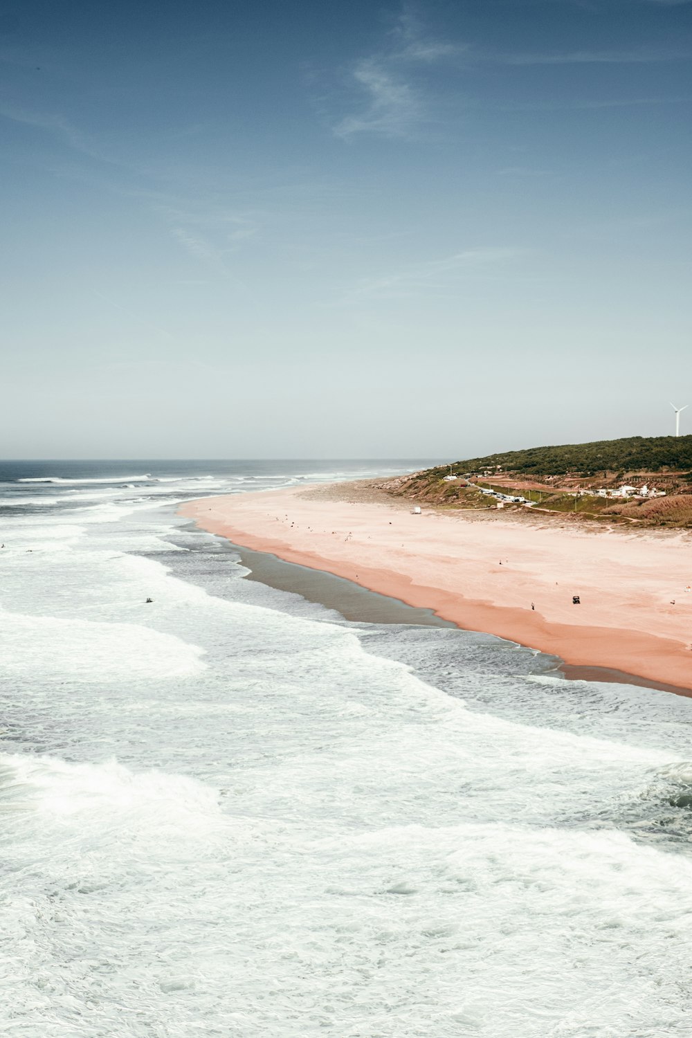 a beach with waves crashing on it