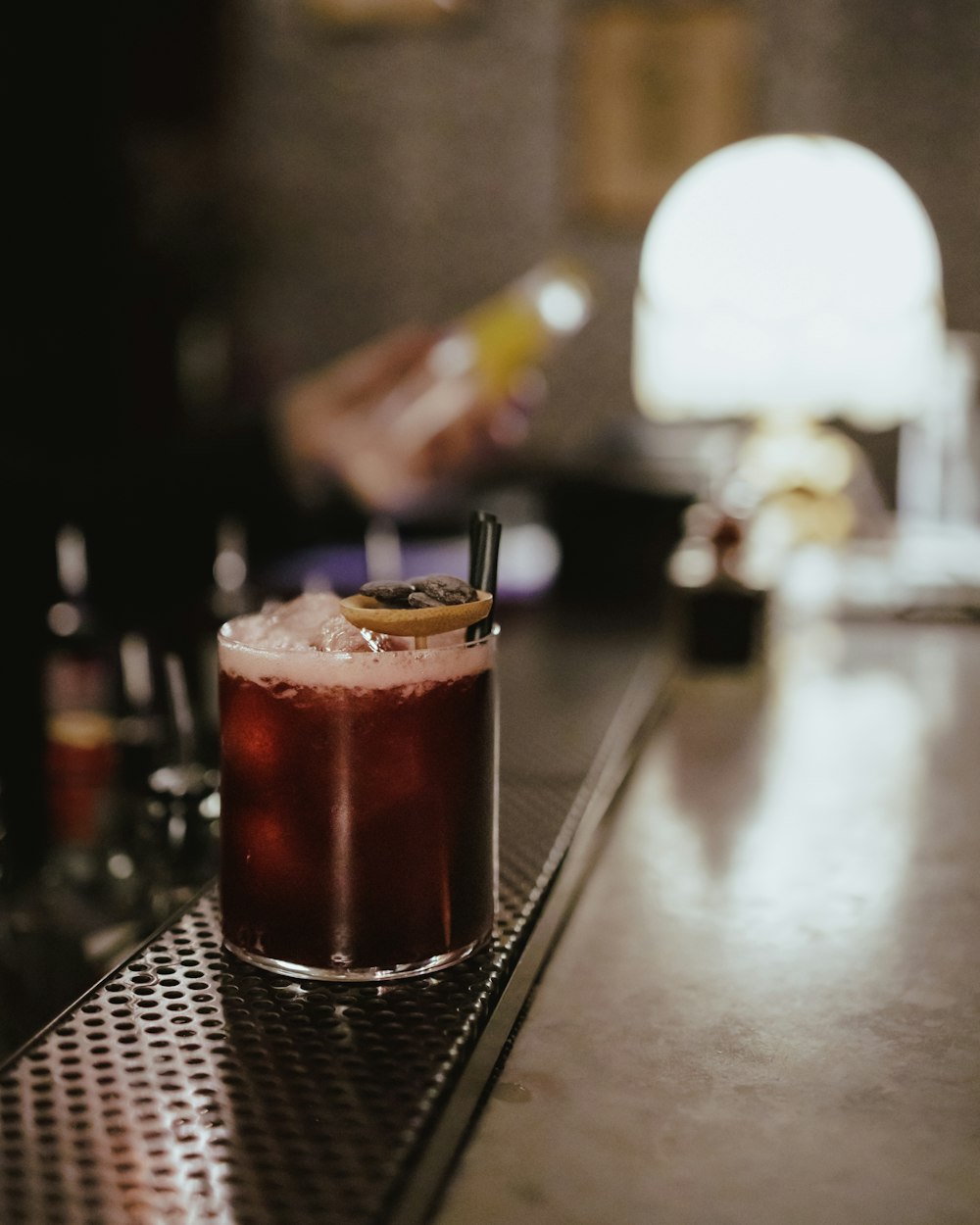 a glass of liquid with a straw