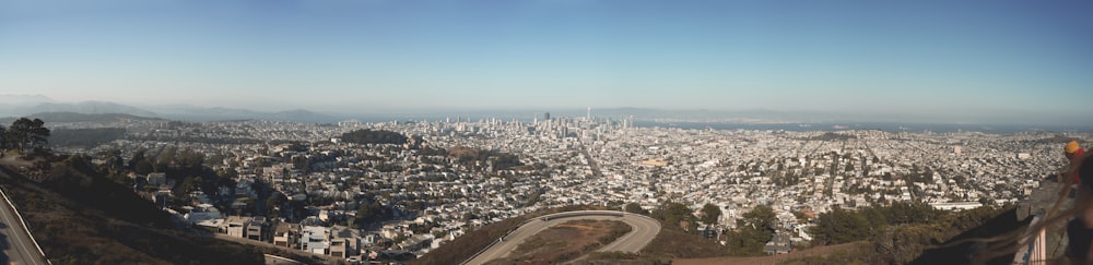 a city with a road and trees