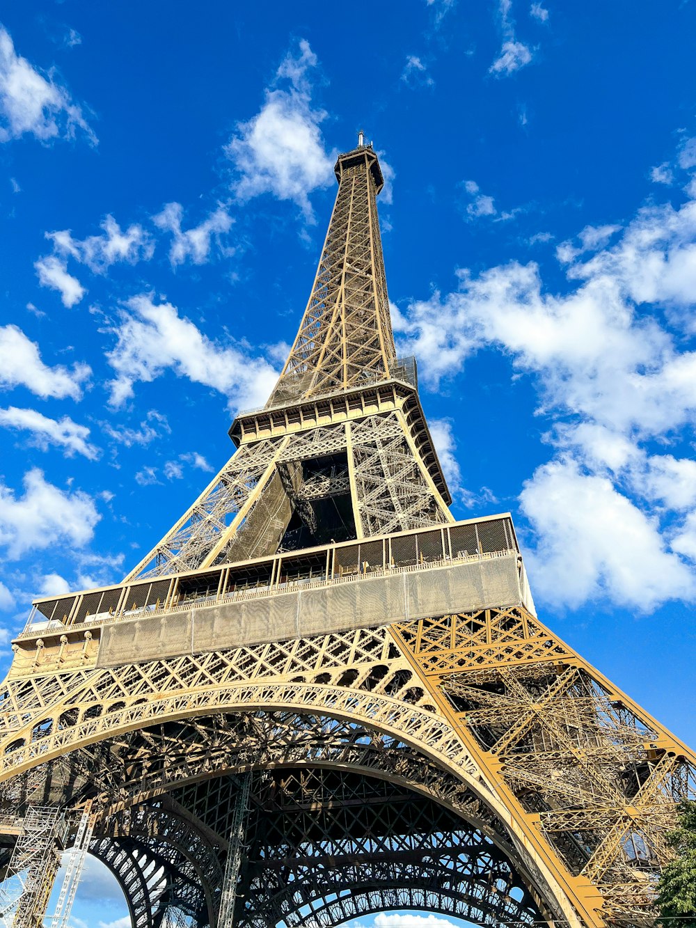 a tall metal tower with Eiffel Tower in the background