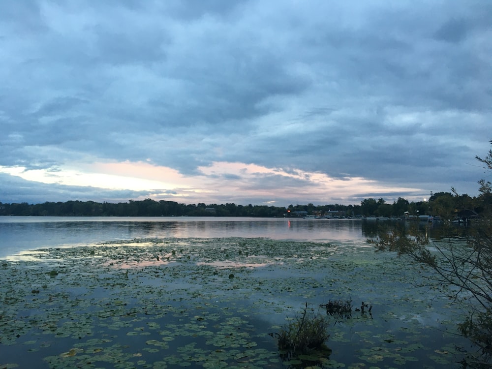 a lake with a cloudy sky