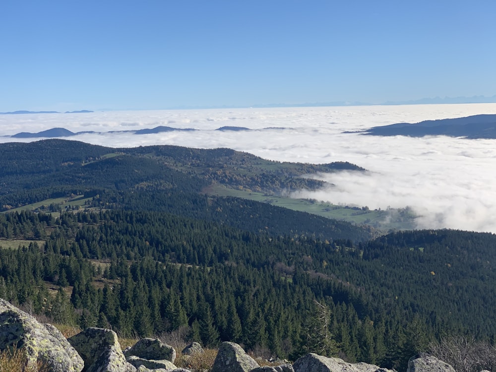 a view of a mountain range and clouds below