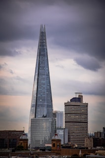 a tall glass building with The Shard in the background