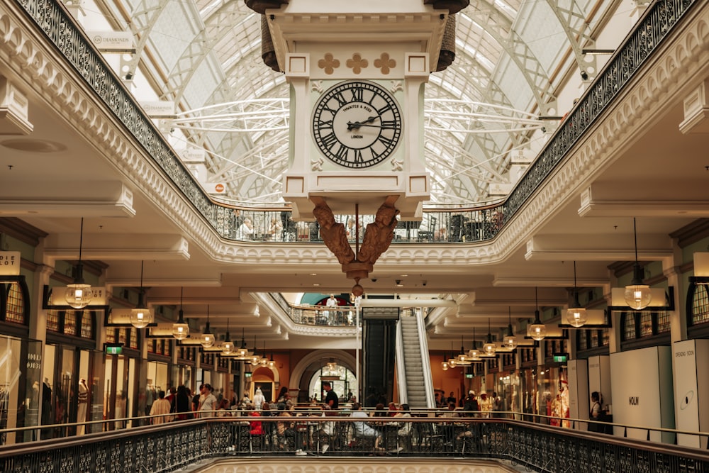 a clock hangs from the ceiling of a building