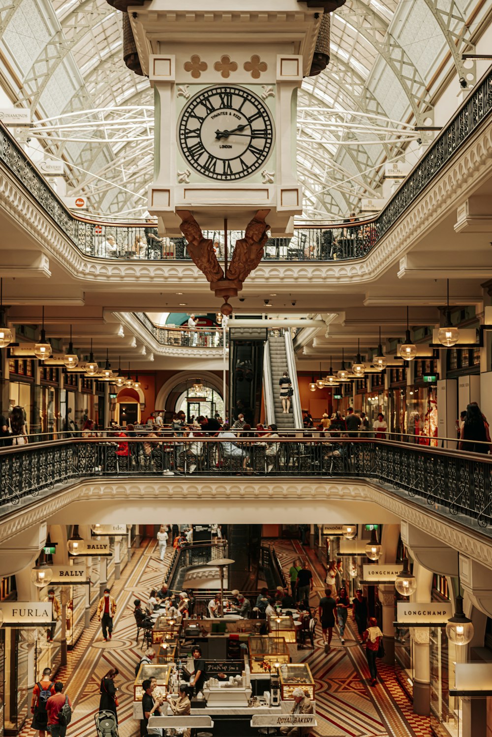 a large clock hangs from the ceiling