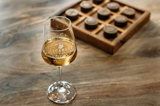 A group of friends enjoying a board game night with wine glasses on the table.